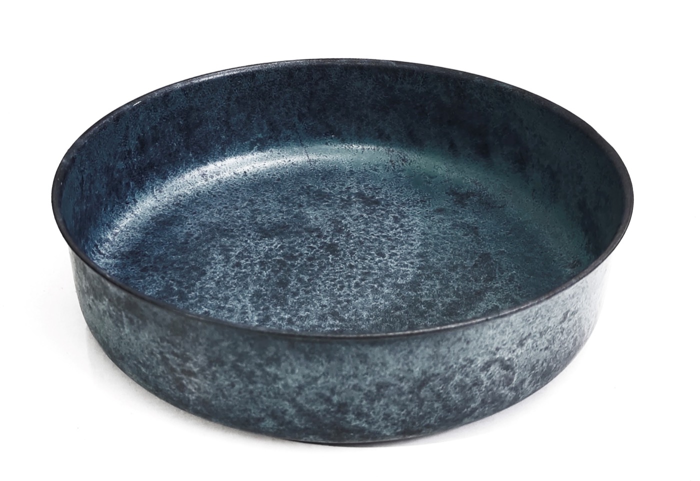 Round galvanized metal tray with a weathered zinc finish