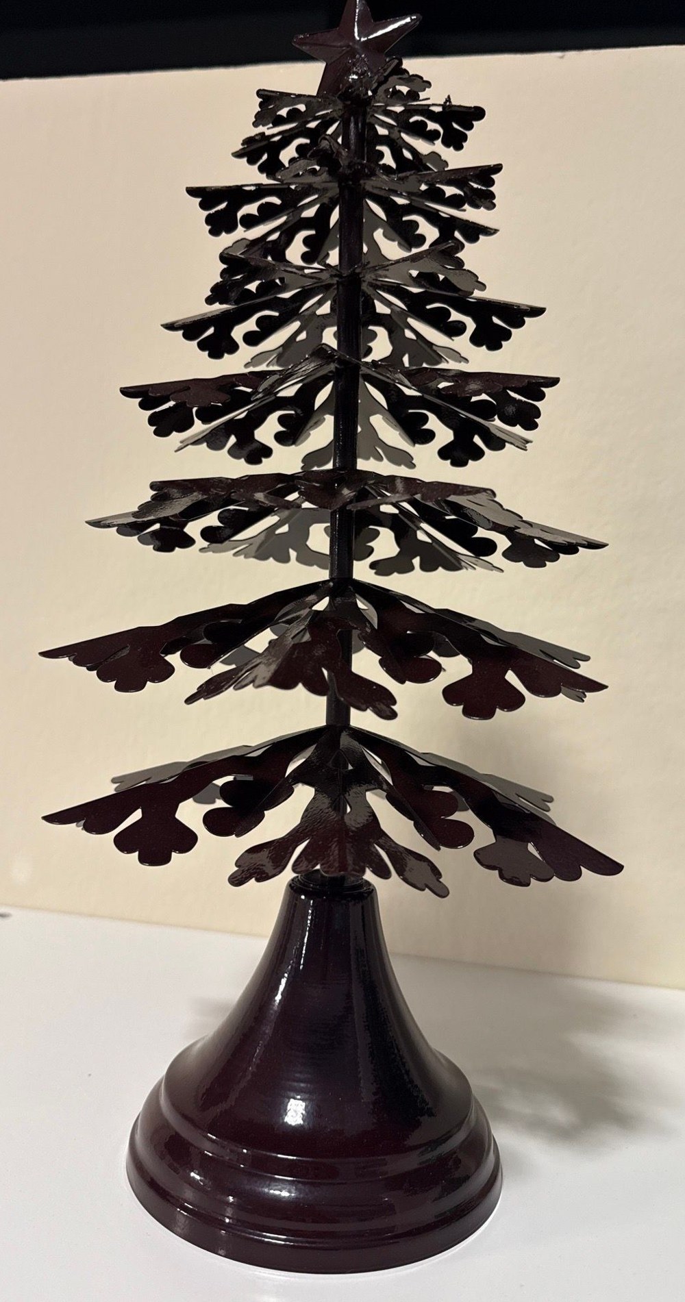Metal galvanized-steel Christmas tree with a star finial on a turned base