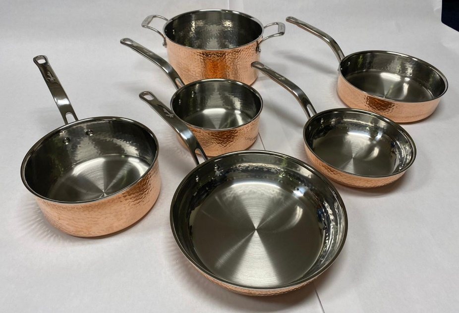 Family of hammered copper pans with stainless interiors