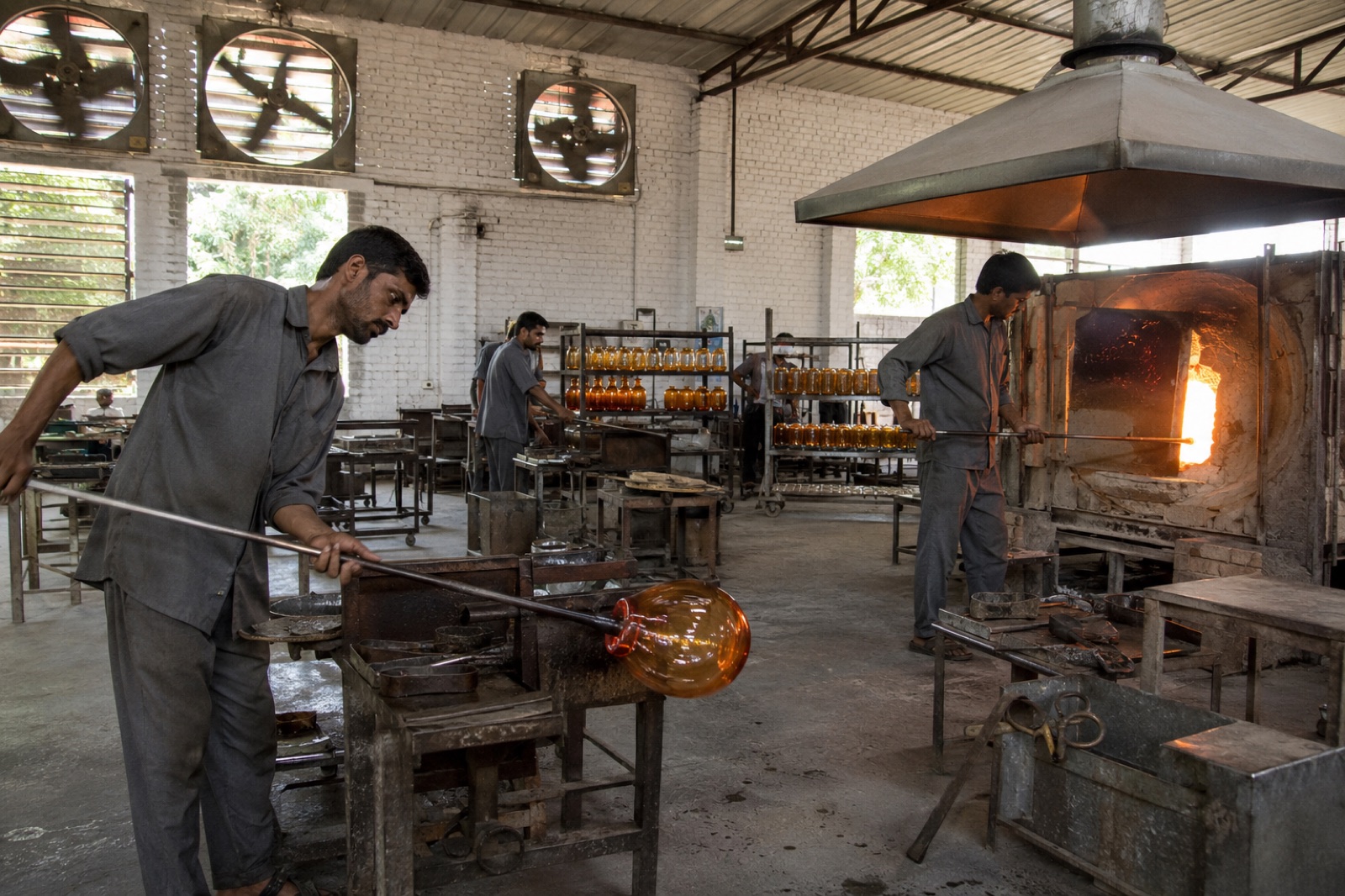 Glassblower shaping molten glass at the Gemixx Firozabad glass hub